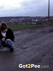 15 pictures - Dark haired babe in denims pees outside