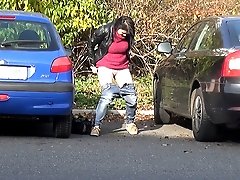 0  - Between parked cars this pretty girl pisses