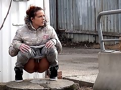 0  - Sexy brunette pissing on an industrial estate