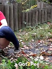 15 pictures - European girl in red tee pisses on fallen leaves