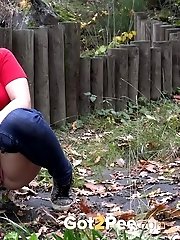 15 pictures - European girl in red tee pisses on fallen leaves