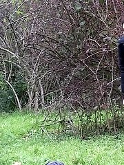 15 pictures - Pretty brunette takes a piss behind a bush