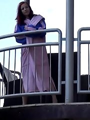 15 pictures - Pretty redhead pisses over her balcony