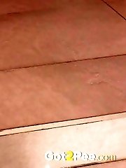 15 pictures - Pretty brunette sprays her piss onto the ground