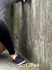 15 pictures - Hot brunette pisses in the middle of the city
