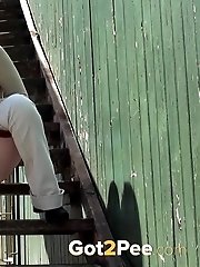 15 pictures - Pretty dark haired girl sprays her piss onto steps