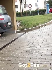 15 pictures - Sexy girl in glasses pisses in a car park space