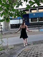 15 pictures - Sexy brunette pisses in the city on drain pipe