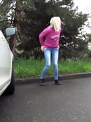 15 pictures - Blonde squats to piss next to a parked car