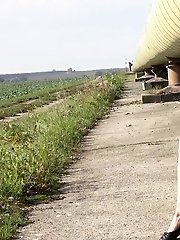 15 pictures - Playful blonde pissing over the ground outside