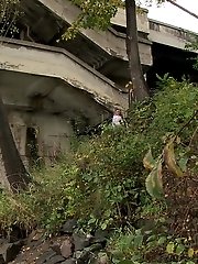 15 pictures - Dark haired girl pisses next to a flowing river