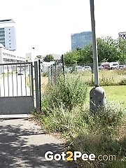 15 pictures - Dark haired girl wearing glasses pees outside