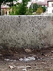 15 pictures - Sitting on a concrete block this brunette pees