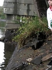 15 pictures - Dark haired girl pisses next to a flowing river