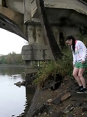 15 pictures - Dark haired girl pisses next to a flowing river