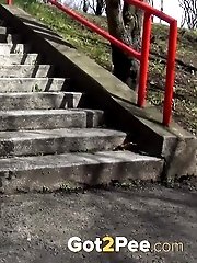 15 pictures - Dark haired girl pisses on concrete steps
