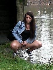 15 pictures - Hot brunette pisses into a flowing river