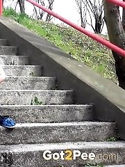 15 pictures - Dark haired girl pisses on concrete steps
