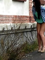 15 pictures - Sexy brunette lifts up her dress to piss