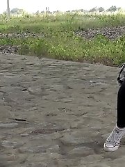15 pictures - Exotic babe squats to piss near main road