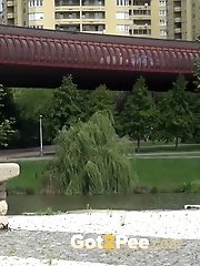 15 pictures - Pretty brunette sits on a concrete bench to pee