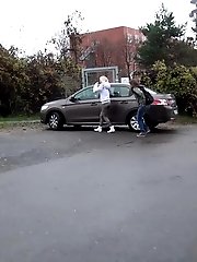 15 pictures - Two friends piss behind a parked car