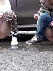 15 pictures - Two friends piss behind a parked car