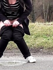 15 pictures - Chubby brunette pisses in the middle of the city