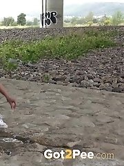 15 pictures - Exotic babe squats to piss near main road