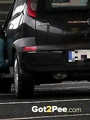 15 pictures - Pretty babe pisses in the middle of a car park