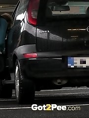 15 pictures - Pretty babe pisses in the middle of a car park