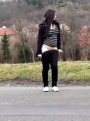 15 pictures - Chubby brunette pisses in the middle of the city