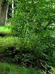 15 pictures - Cute brunette pisses next to the riverbank