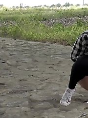 15 pictures - Exotic babe squats to piss near main road