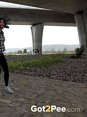 15 pictures - Exotic babe squats to piss near main road