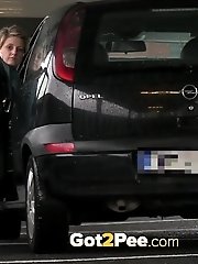 15 pictures - Pretty babe pisses in the middle of a car park