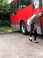 15 pictures - Busty brunette pees behind a bus