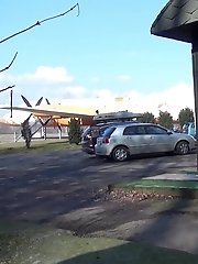 15 pictures - Pretty brunette pisses in public by the airport