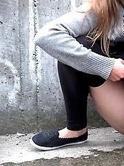 15 pictures - Hot brunette pisses in the middle of the city