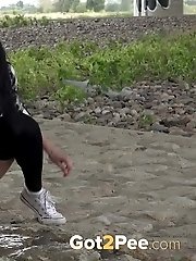 15 pictures - Exotic babe squats to piss near main road