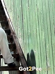 15 pictures - Pretty dark haired girl sprays her piss onto steps