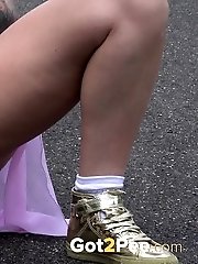 15 pictures - Tattooed blonde empties her bladder outside