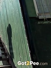 15 pictures - Pretty dark haired girl sprays her piss onto steps