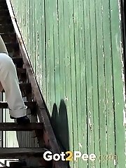 15 pictures - Pretty dark haired girl sprays her piss onto steps
