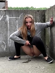 15 pictures - Hot brunette pisses in the middle of the city