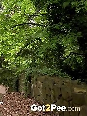 15 pictures - Dark haired hottie in stockings pisses outside