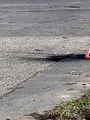 15 pictures - Brunette girl makes a pissy puddle on the road