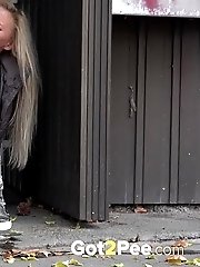 15 pictures - Cute blonde pisses in public in the city