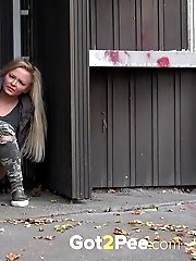 15 pictures - Cute blonde pisses in public in the city