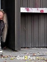 15 pictures - Cute blonde pisses in public in the city